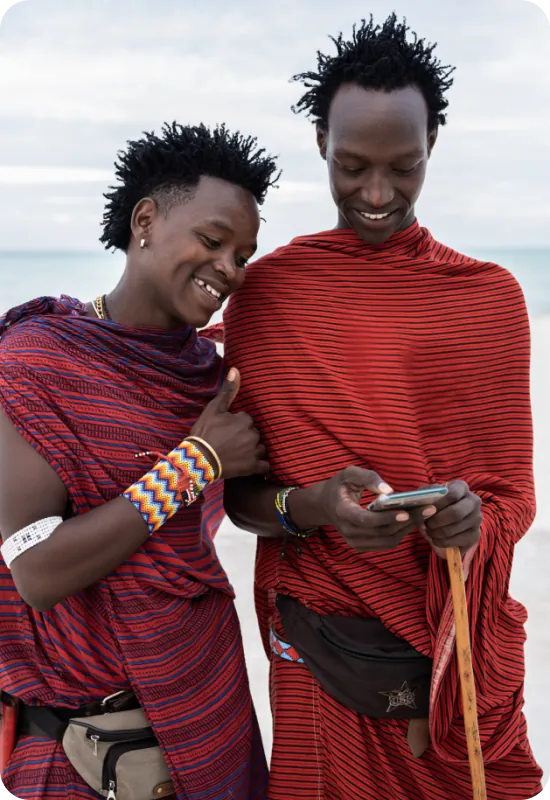 Two people laughing and looking at a cellphone